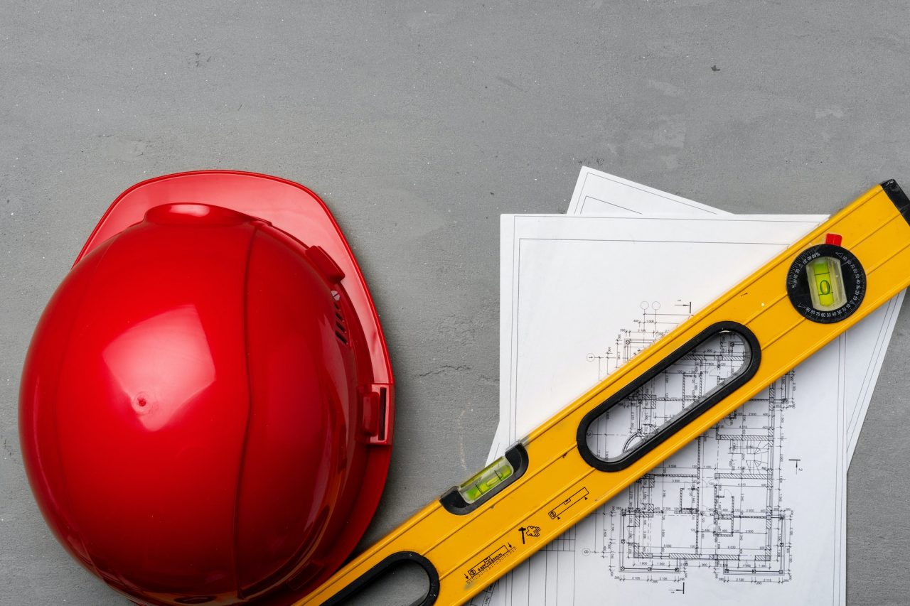 construction worker hardhat blueprints and construction level top view